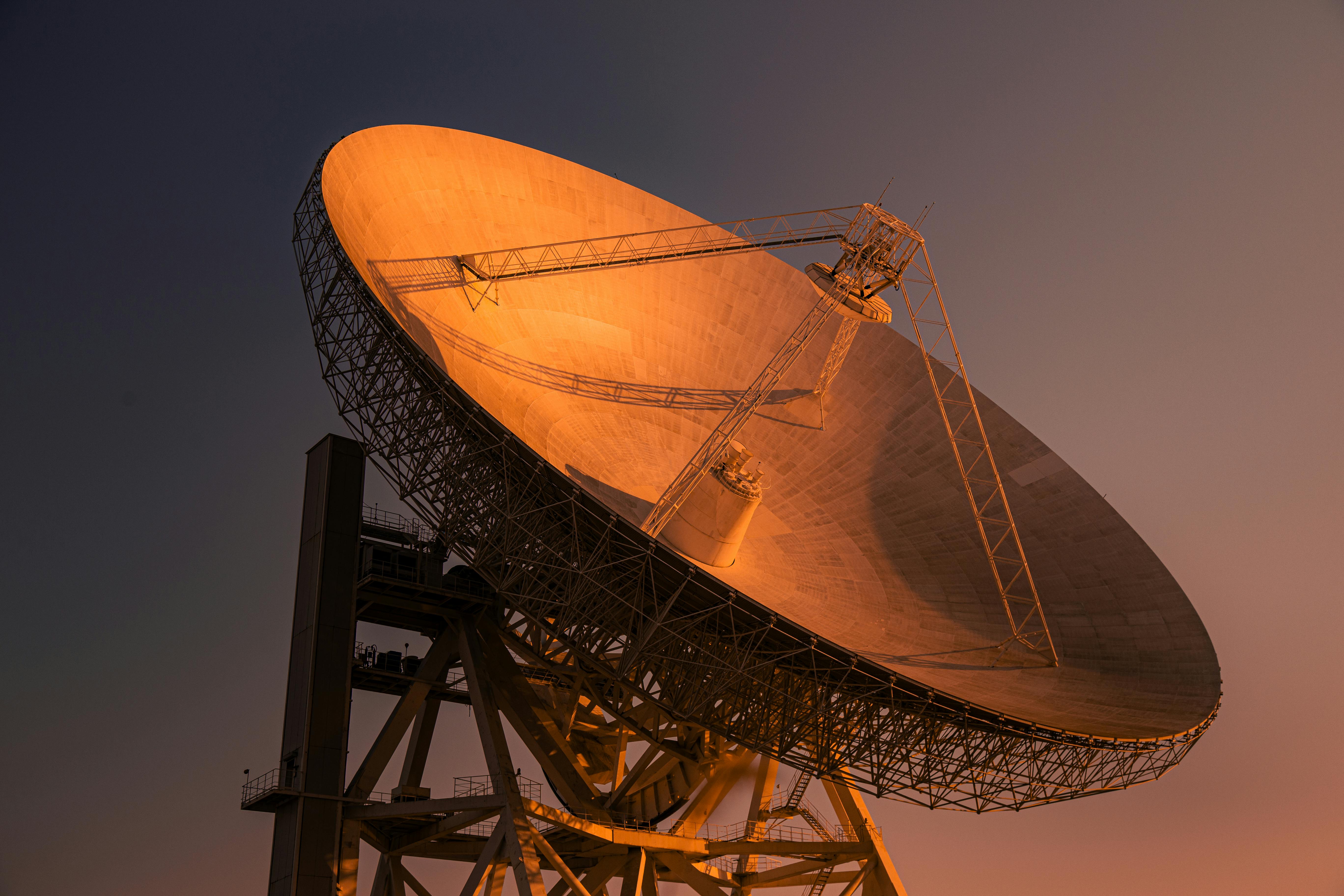 Large radio telescope at sunset